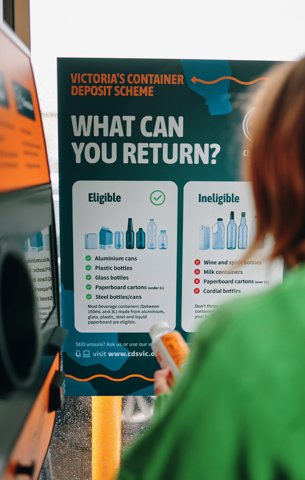 person viewing the victoria container deposit scheme signage